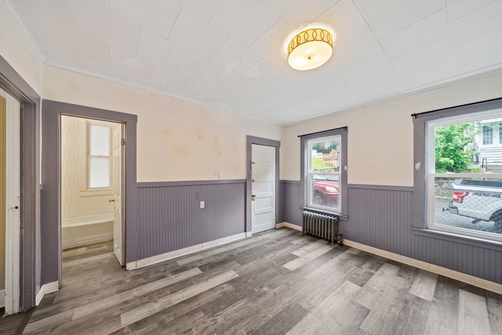 20 Rodney Street Worcester, MA 01605 - Photo 5 of 35 a view of an empty room with window and wooden floor