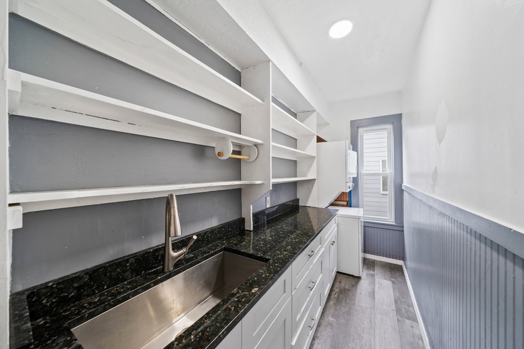 20 Rodney Street Worcester, MA 01605 - Photo 6 of 35 a kitchen with granite countertop a stove and a refrigerator