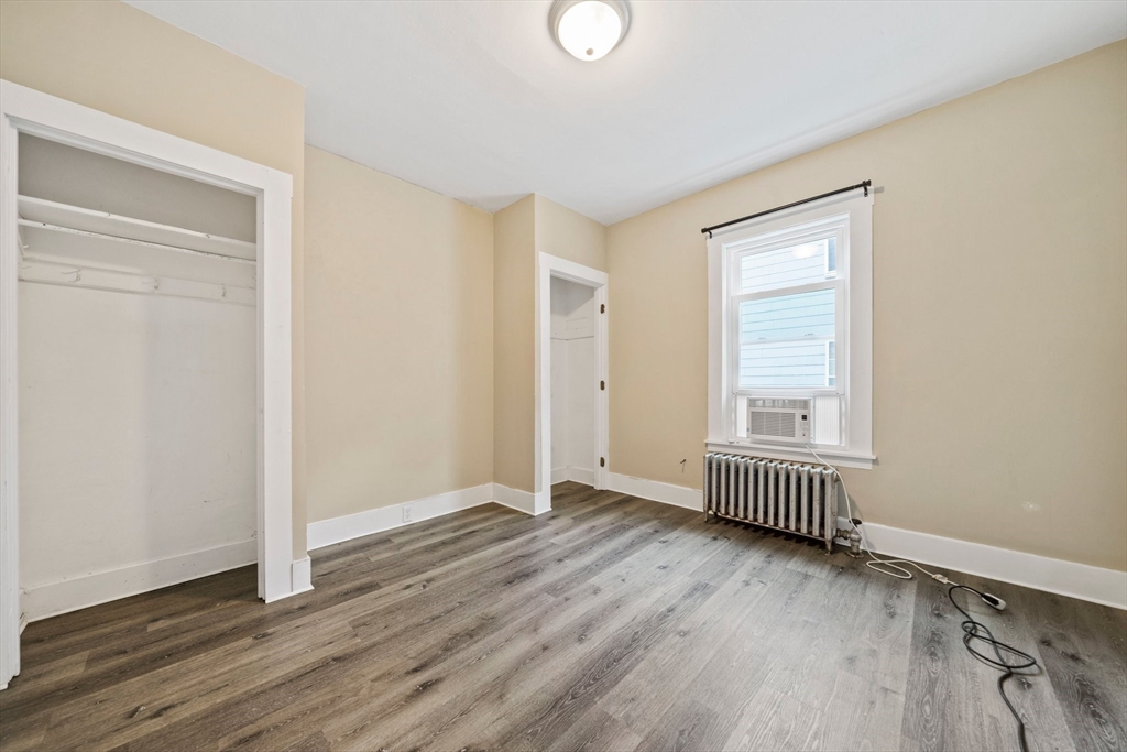 20 Rodney Street Worcester, MA 01605 - Photo 7 of 35 an empty room with wooden floor and windows