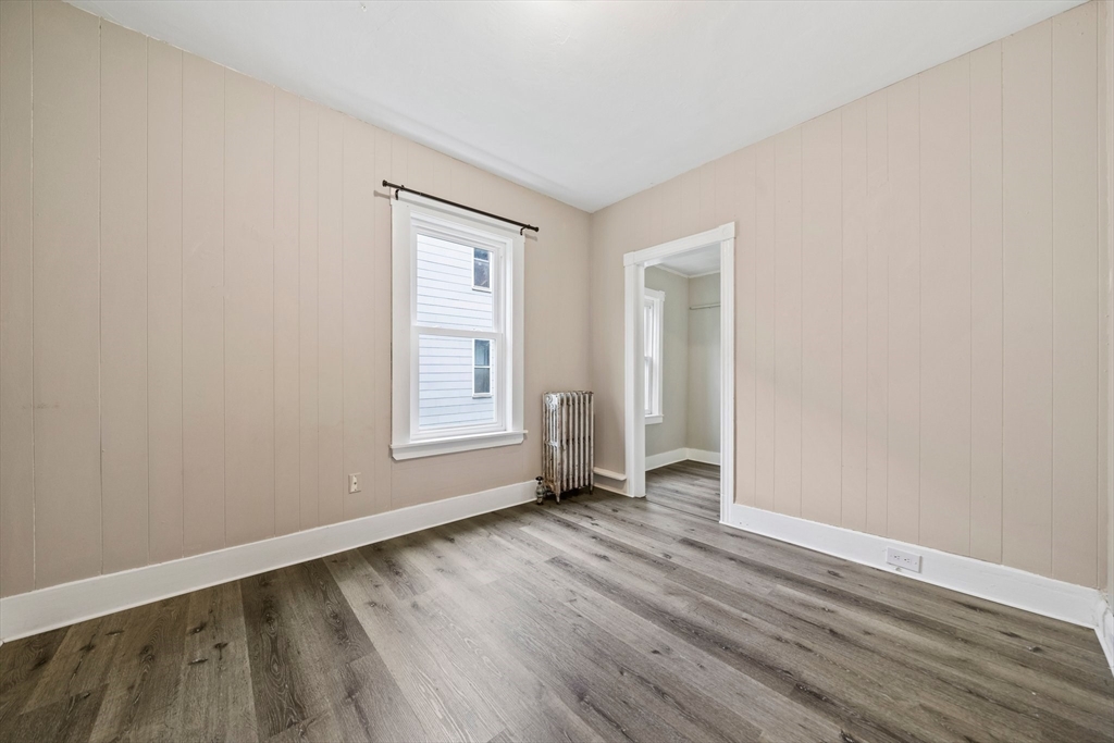 20 Rodney Street Worcester, MA 01605 - Photo 9 of 35 an empty room with wooden floor and windows