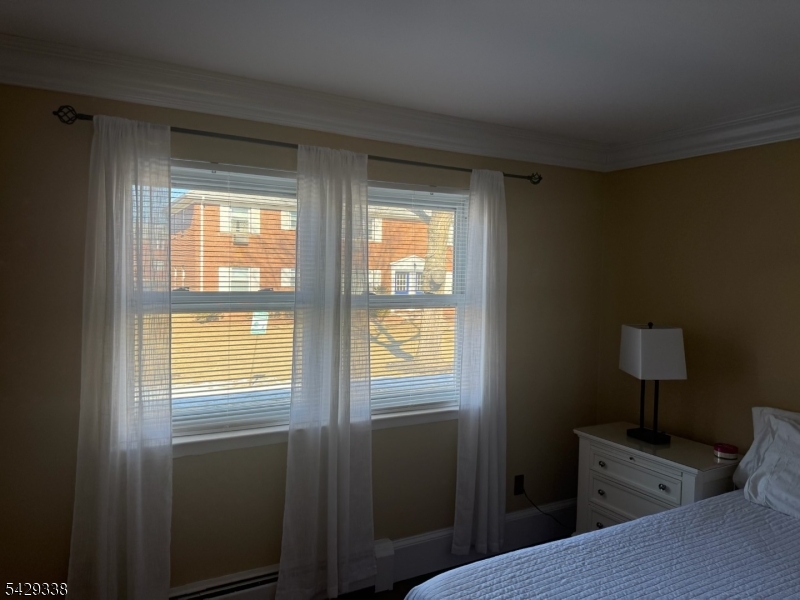 1173 Valley Road Wayne, NJ 07470 - Photo 8 of 11 a bedroom with a bed and a window