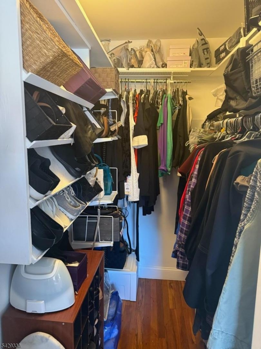 1173 Valley Road Wayne, NJ 07470 - Photo 9 of 11 a view of walk in closet with clothes and shoes