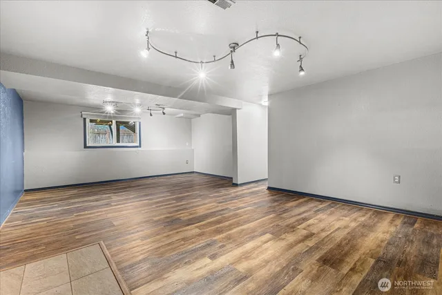 a view of a room with wooden floor and white walls