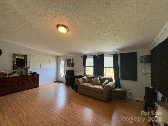 a view of a livingroom with wooden floor and cabinet