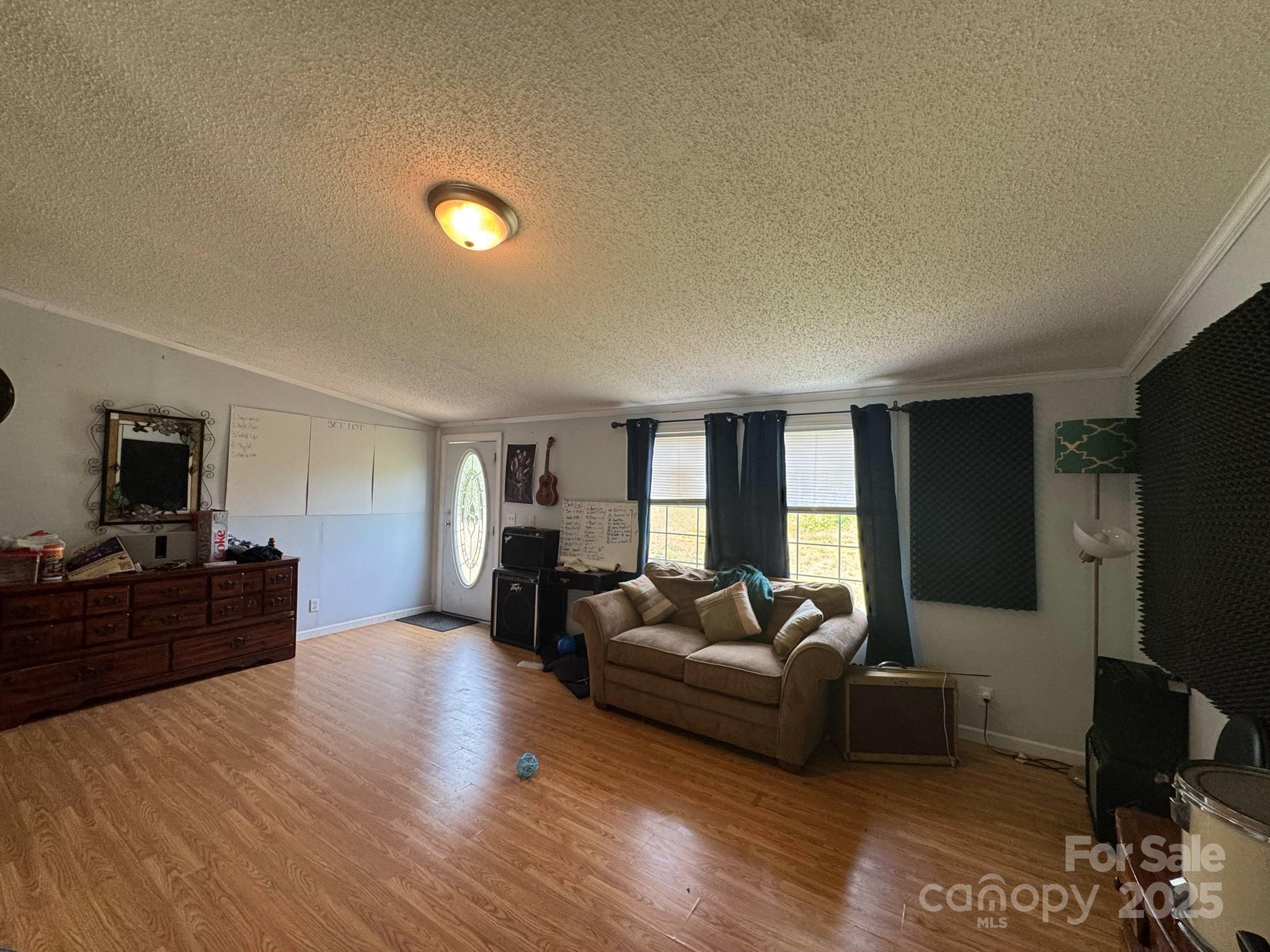 2194 Sterling Ridge Drive Newton, NC 28658 - Photo 9 of 26 a living room with furniture a flat screen tv and a refrigerator