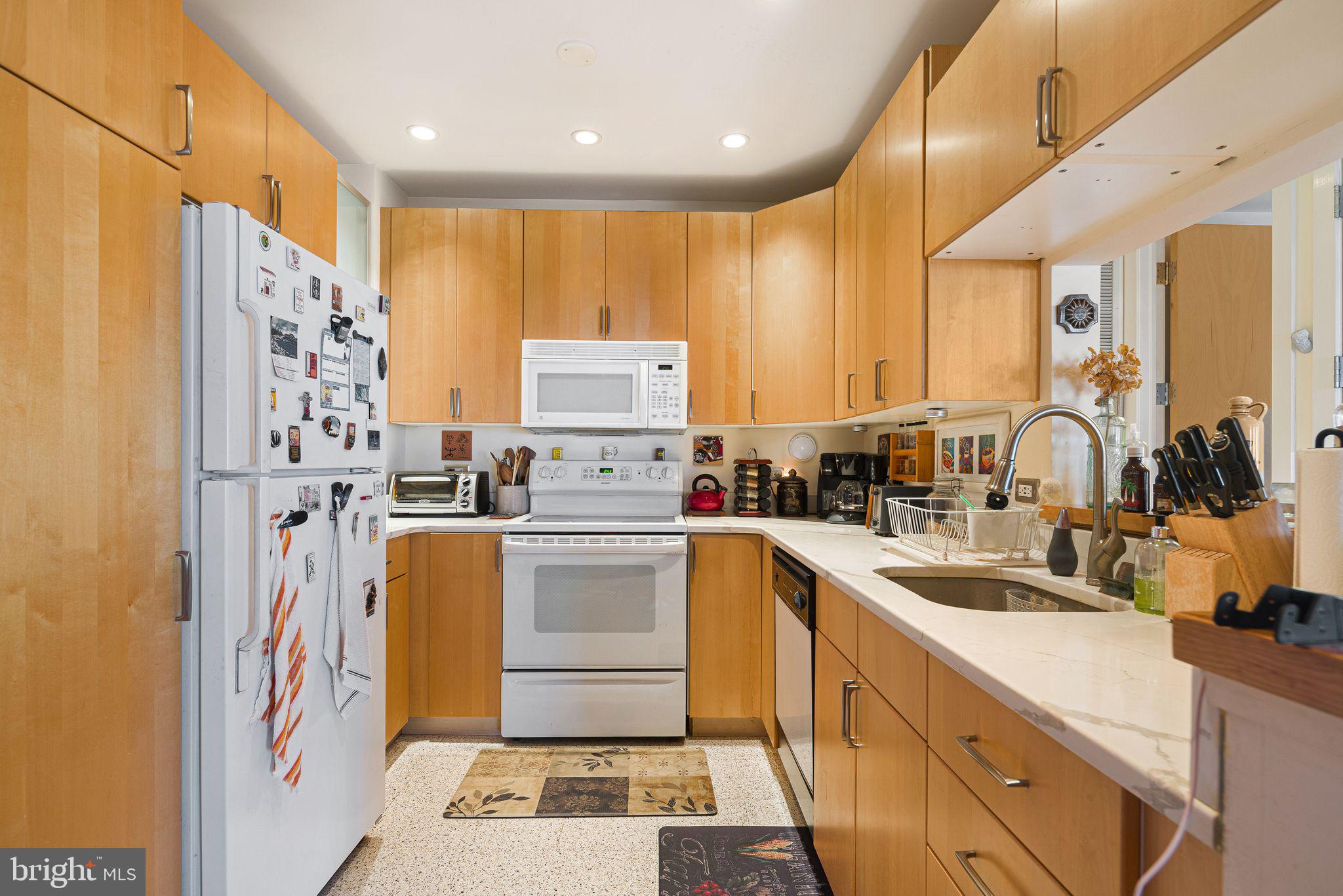214 New Street, Unit C Philadelphia, PA 19106 - Photo 11 of 29 a kitchen with refrigerator a sink and cabinets