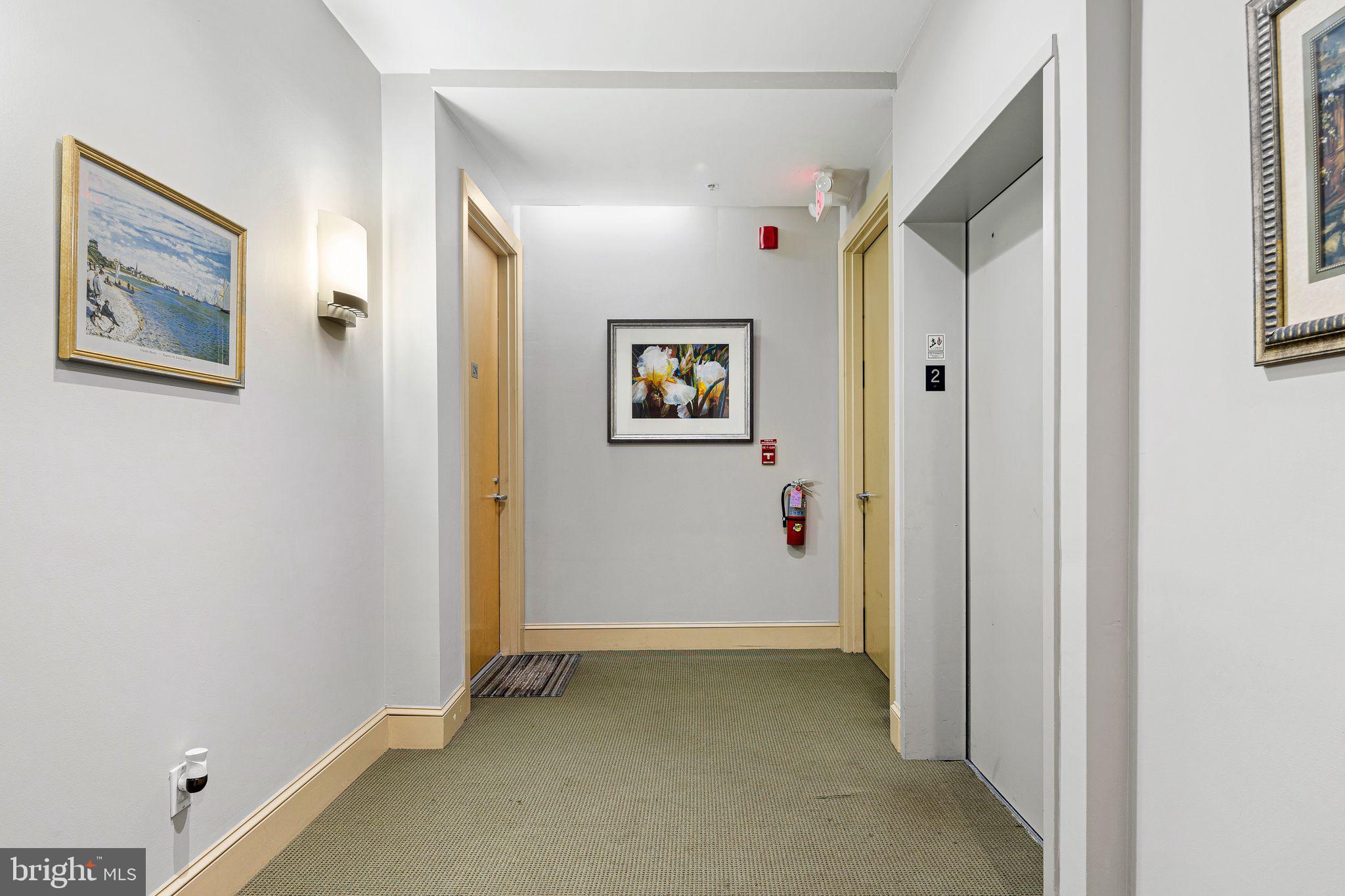 214 New Street, Unit C Philadelphia, PA 19106 - Photo 21 of 29 a view of a hallway with paintings on the wall