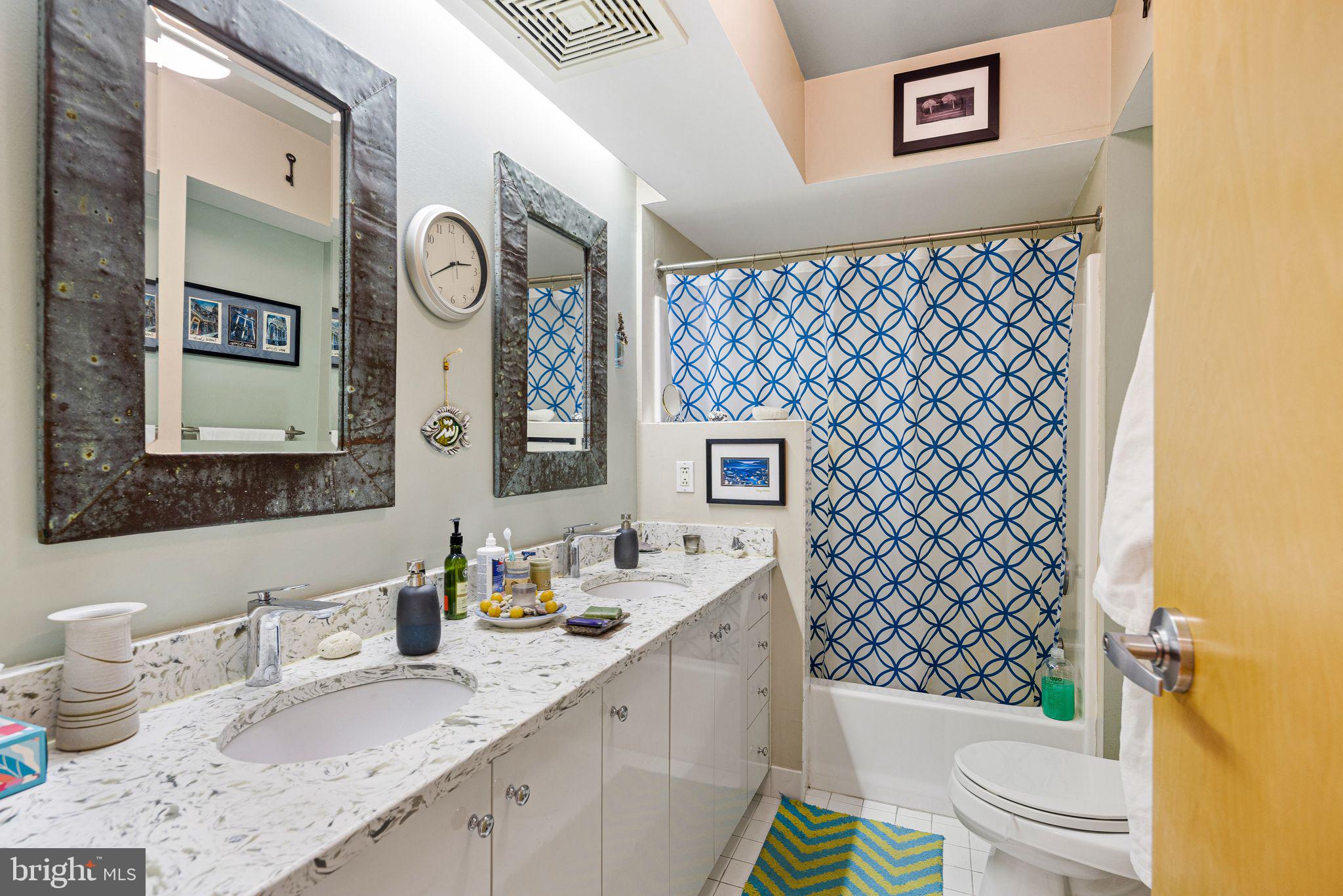214 New Street, Unit C Philadelphia, PA 19106 - Photo 10 of 29 a bathroom with a granite countertop toilet sink and mirror