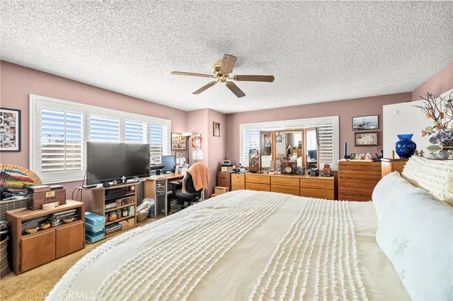 a bedroom with a bed and glass windows