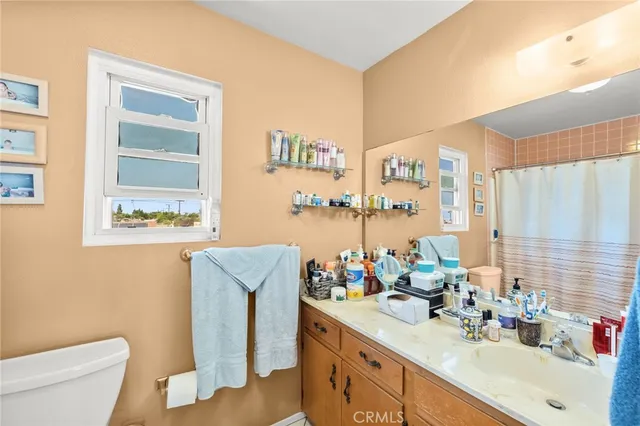 a bathroom with a sink mirror vanity and toilet