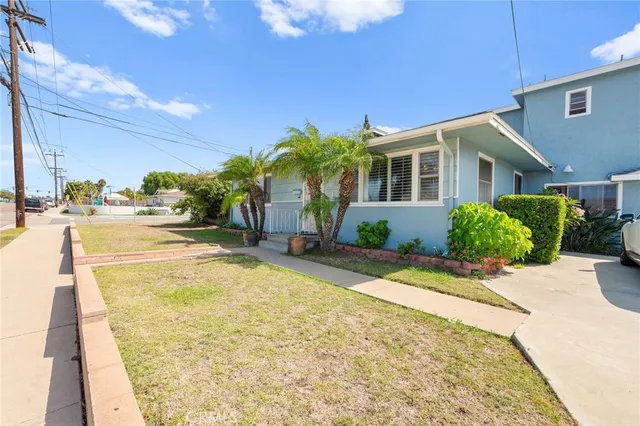 a view of yellow house with swimming pool