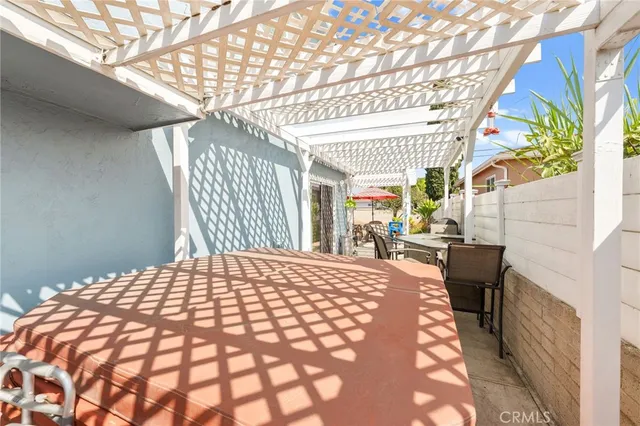 a view of a patio with table and chairs and potted plants
