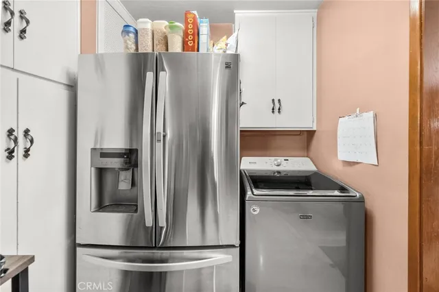 a kitchen with a refrigerator and a stove top oven