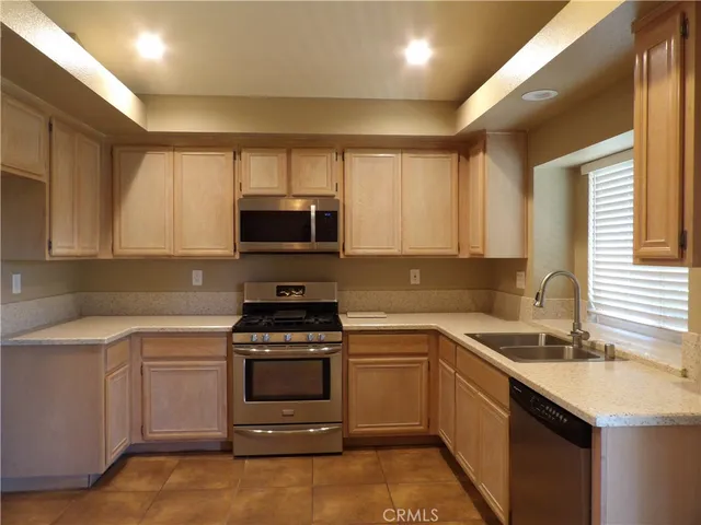 a kitchen with a sink stove and microwave