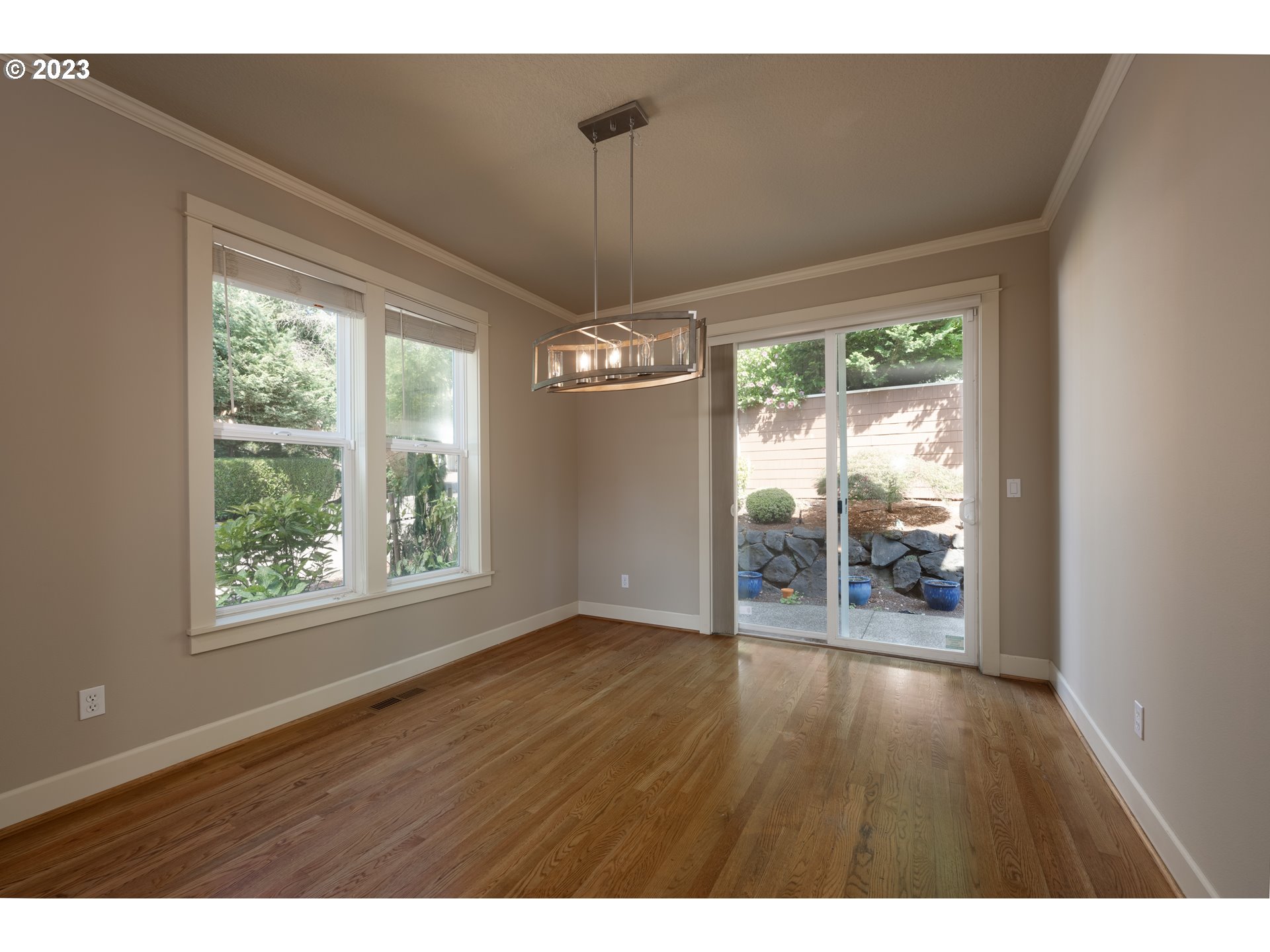 2213 St Moritz Loop West Linn, OR 97068 - Photo 11 of 48 a view of an empty room with wooden floor and a window