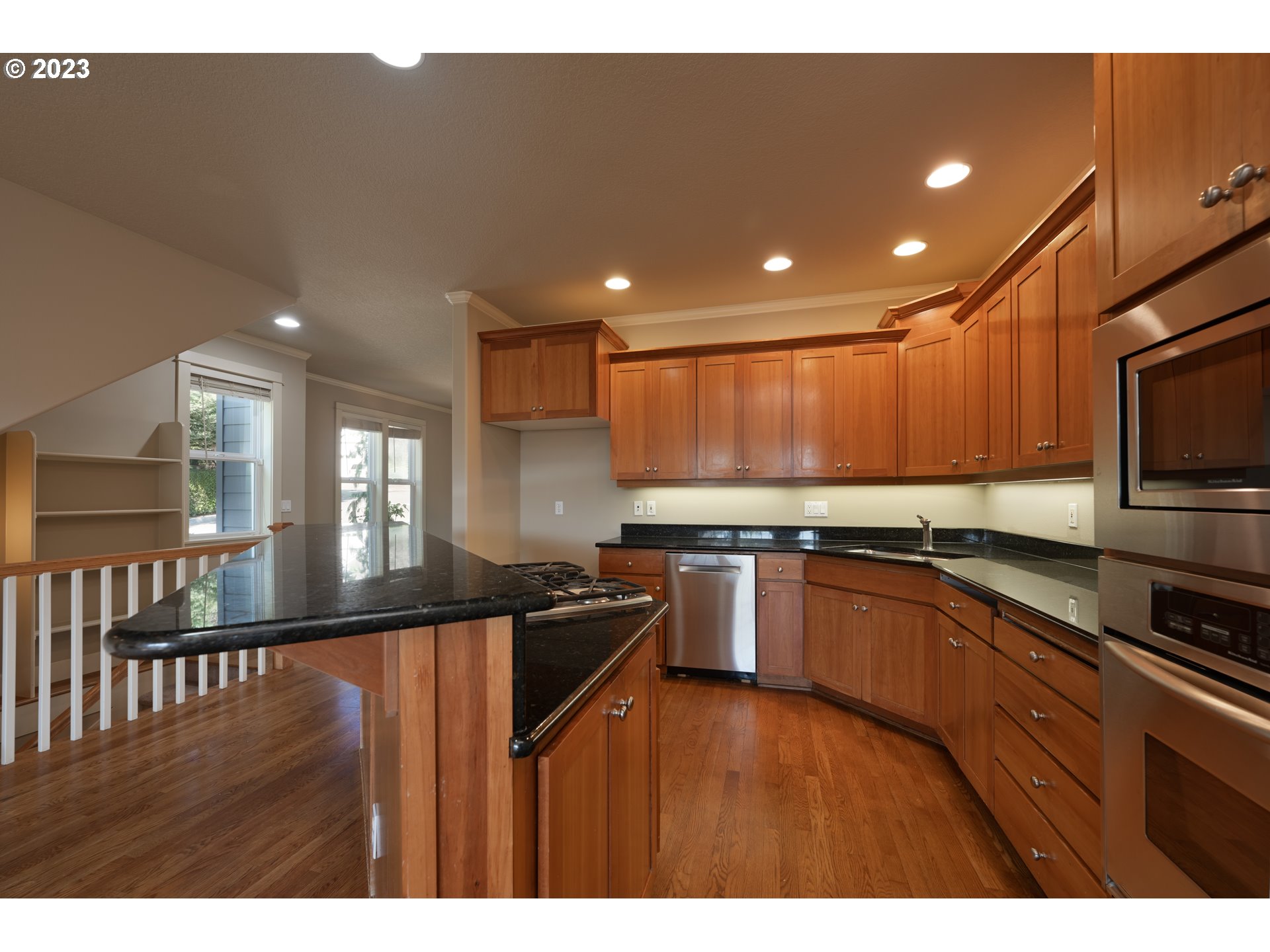 2213 St Moritz Loop West Linn, OR 97068 - Photo 19 of 48 a kitchen with stainless steel appliances granite countertop a sink a stove top oven and a refrigerator