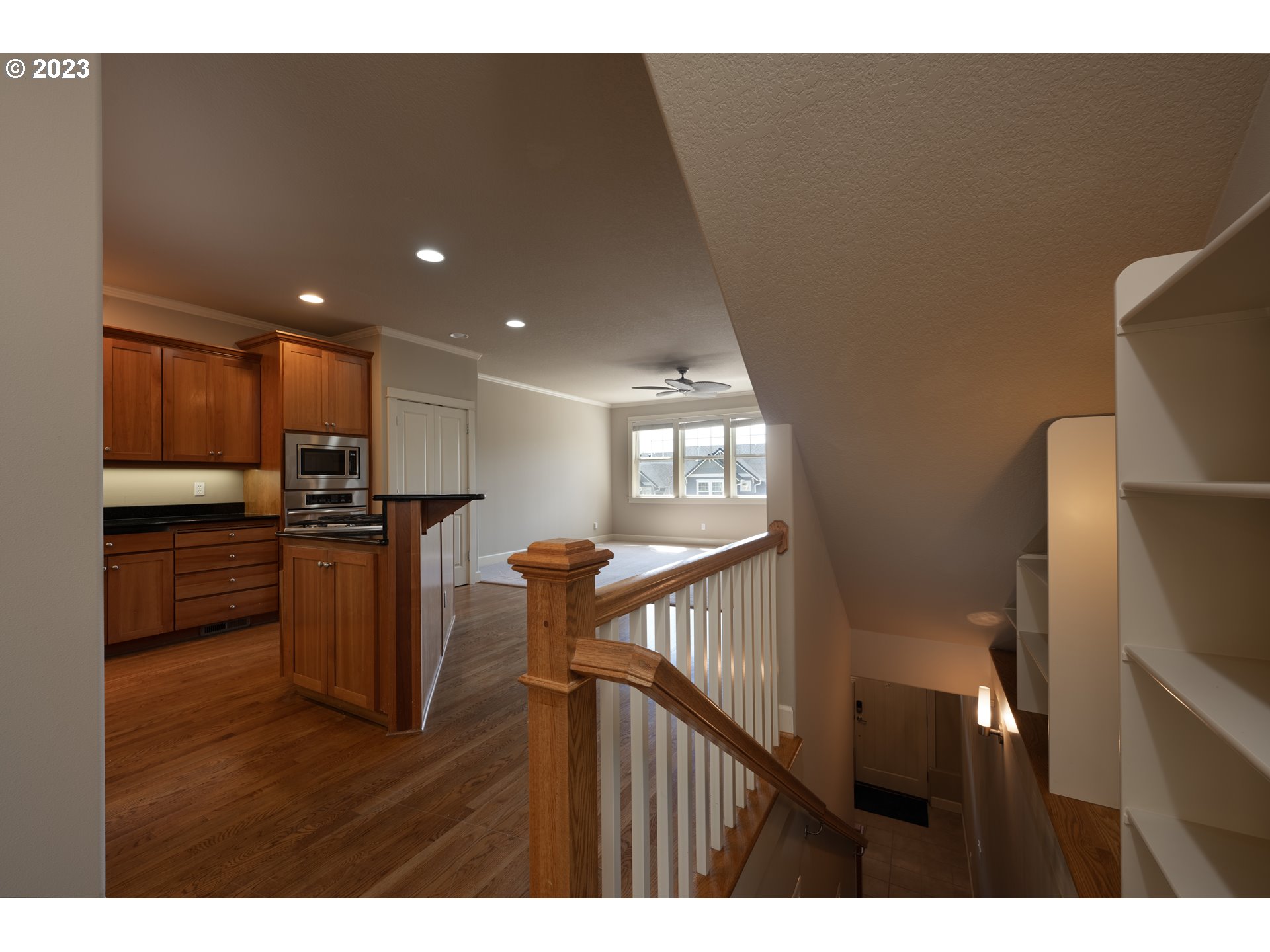2213 St Moritz Loop West Linn, OR 97068 - Photo 25 of 48 a open kitchen with kitchen island wooden floors and stainless steel appliances