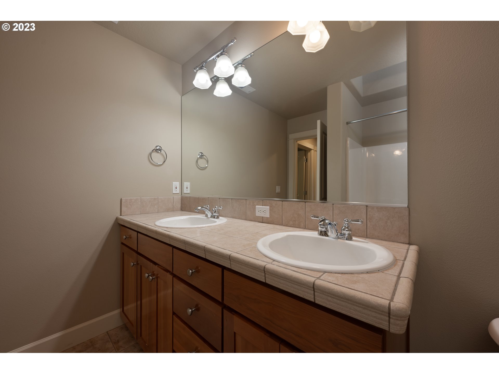 2213 St Moritz Loop West Linn, OR 97068 - Photo 33 of 48 a bathroom with a sink vanity and a mirror