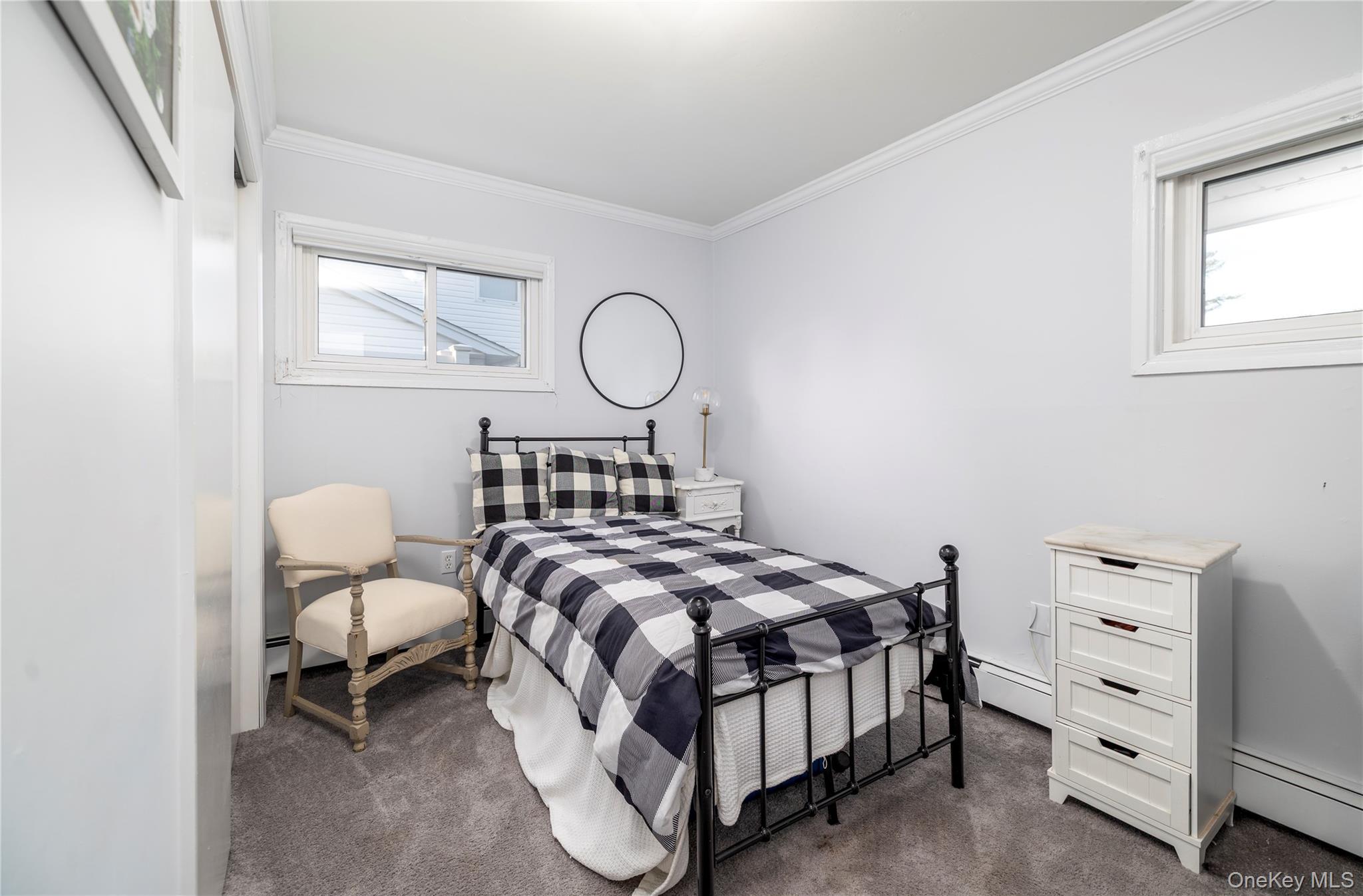 10 Rural Lane Levittown, NY 11756 - Photo 14 of 22 a bedroom with a bed window and a chair