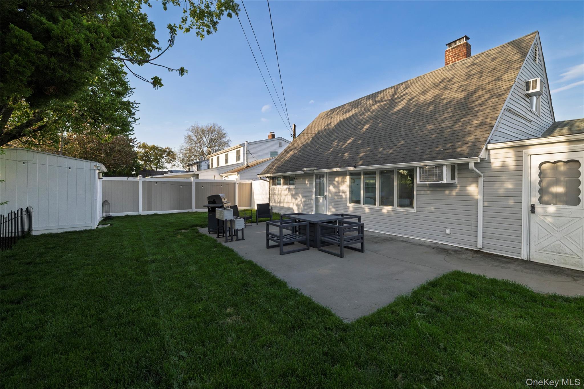 10 Rural Lane Levittown, NY 11756 - Photo 20 of 22 a view of a house with backyard and sitting area