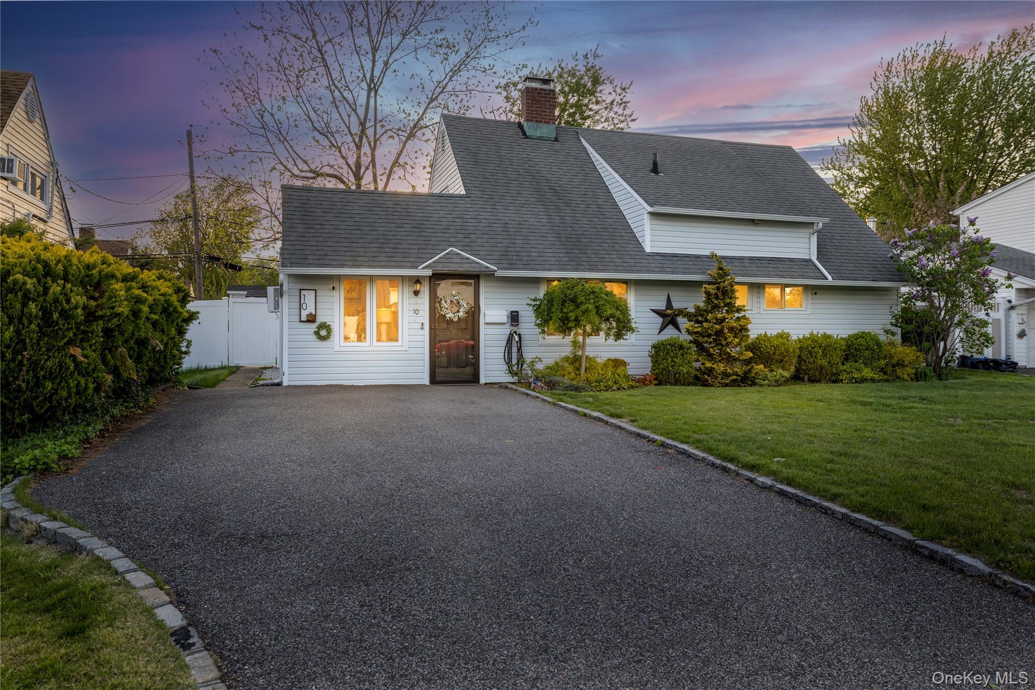 10 Rural Lane Levittown, NY 11756 - Photo 2 of 22 a front view of house with yard and green space