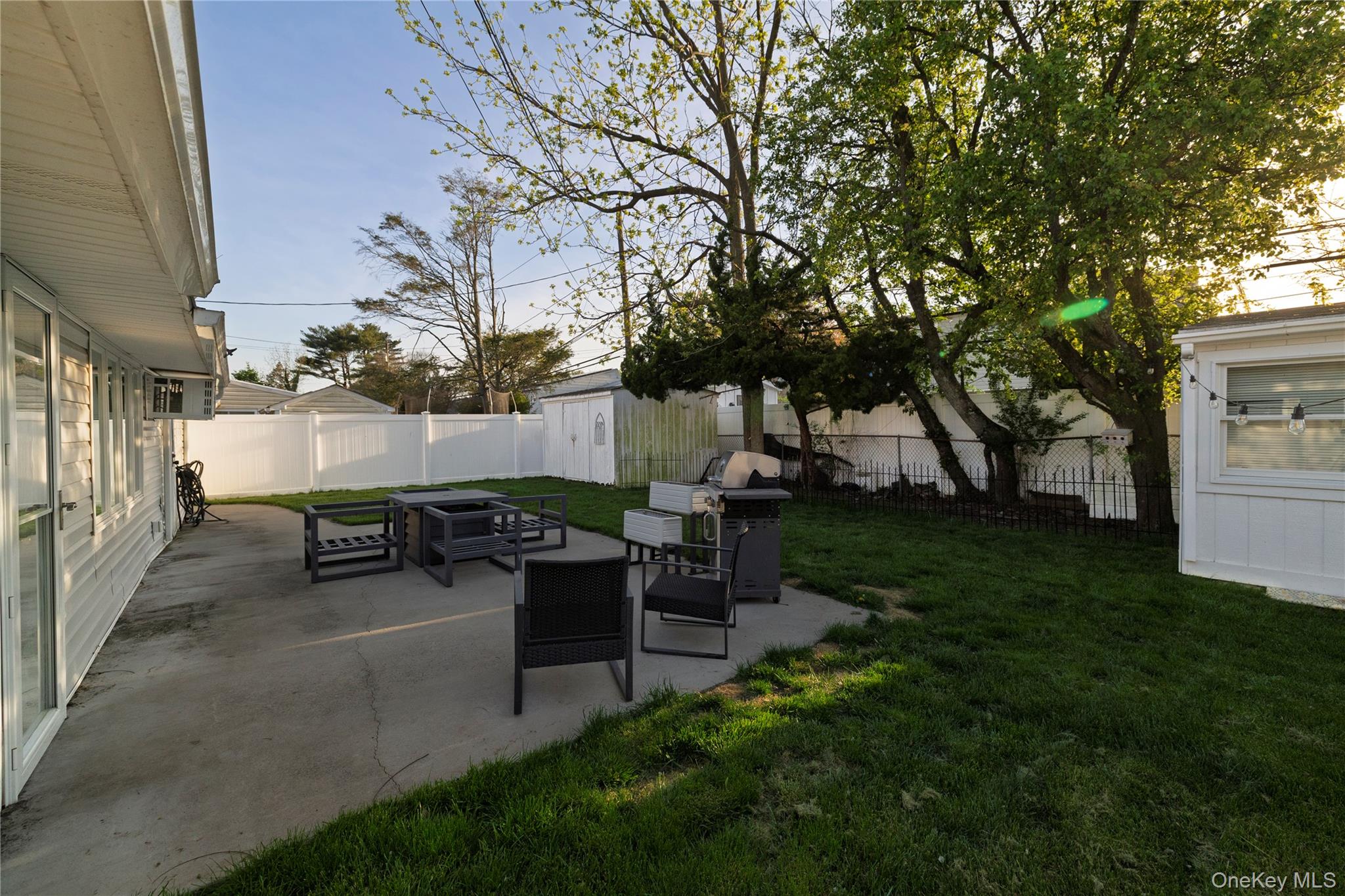 10 Rural Lane Levittown, NY 11756 - Photo 21 of 22 a view of a backyard with sitting area
