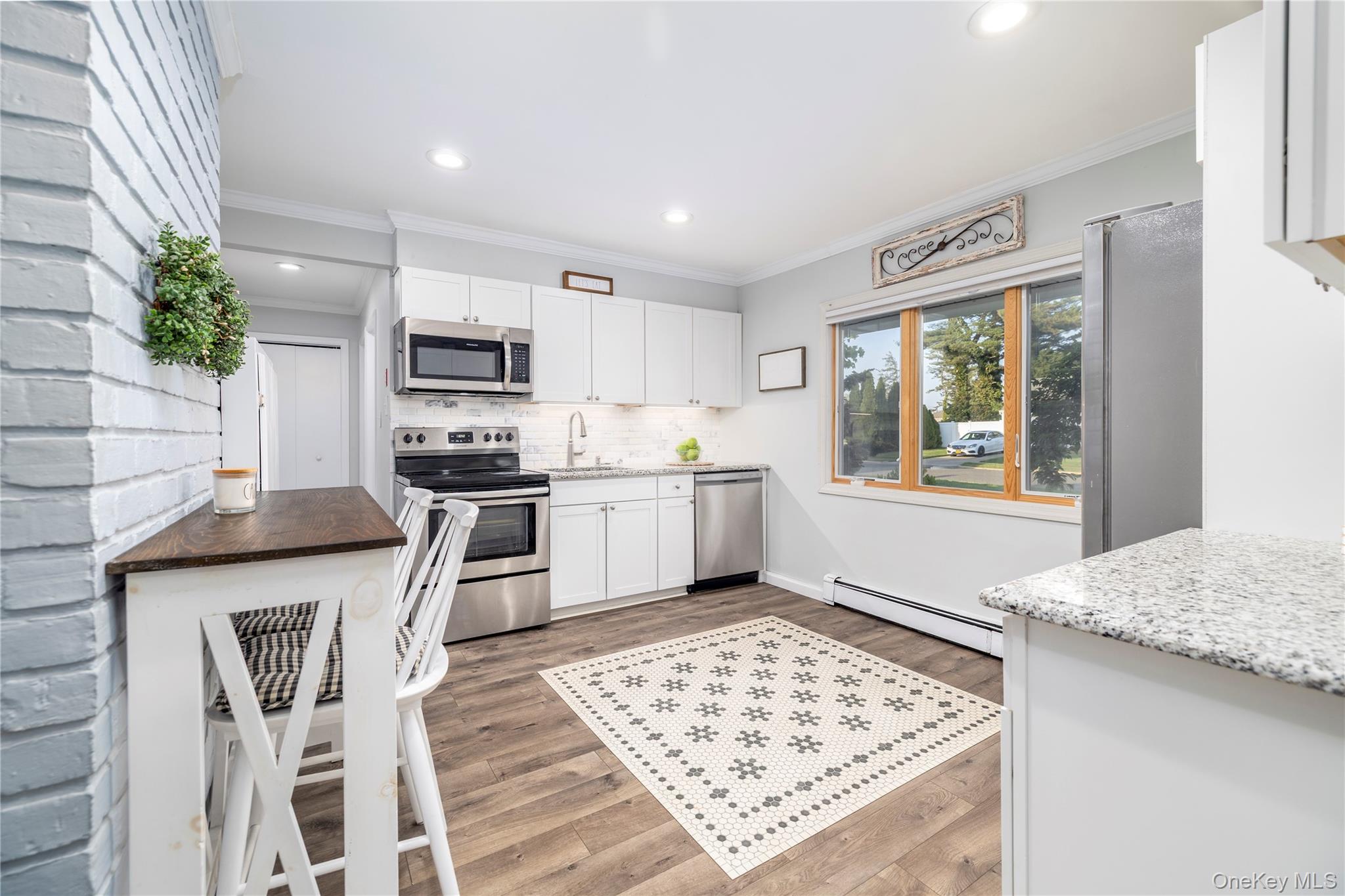 10 Rural Lane Levittown, NY 11756 - Photo 7 of 22 a kitchen with a stove a sink and a refrigerator