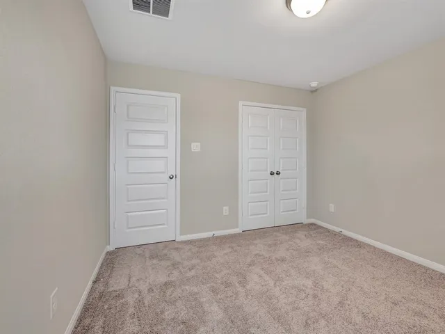 an empty room with closet area