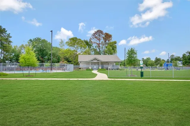 a view of a house with a backyard and a slide