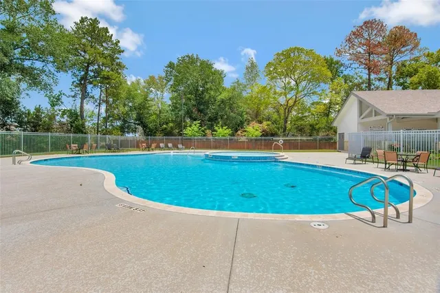 a view of swimming pool with deck and yard