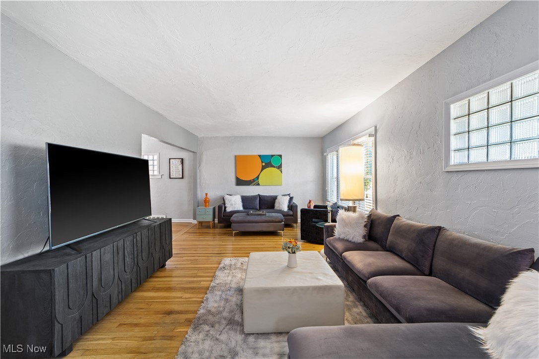 13629 Cedar Road Cleveland, OH 44118 - Photo 2 of 12 Living room featuring a textured wall and light wood-type flooring