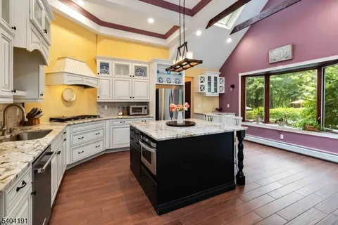 a kitchen with stainless steel appliances granite countertop a stove and a sink