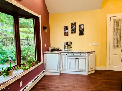 a spacious bathroom with a granite countertop sink and a large mirror next to a window