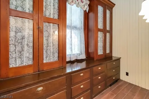 a view of a dining room with furniture a chandelier and wooden floor