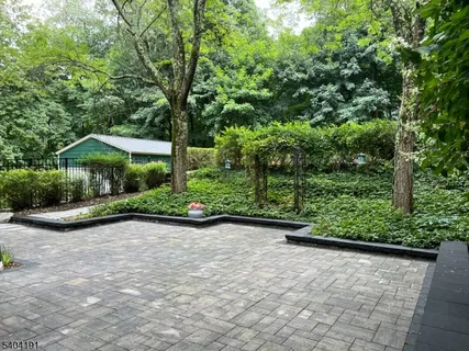 a view of swimming pool with outdoor seating and garden