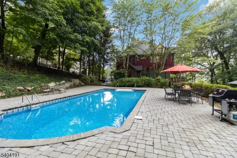 a front view of a house with yard and green space