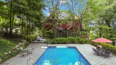 a front view of a house with yard and tree s