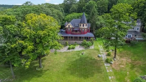 an aerial view of a house with outdoor space and street view
