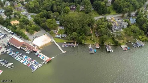 a view of a brick house with large windows and a small yard