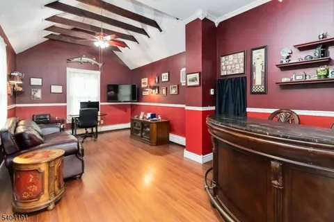 a living room with furniture gym equipment and a chandelier