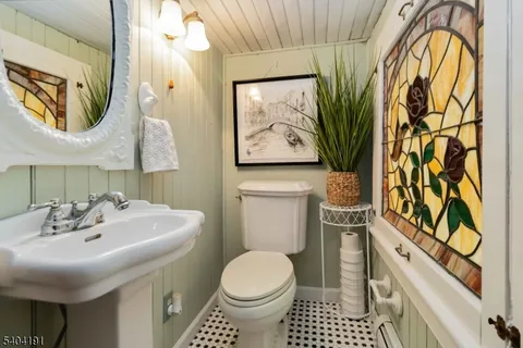 a bathroom with a sink toilet and mirror