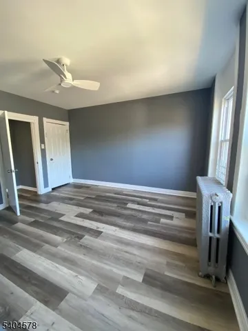 a view of room with staircase and a ceiling fan