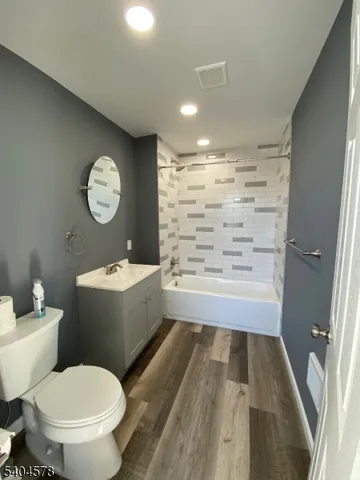 a bathroom with a sink mirror vanity and toilet