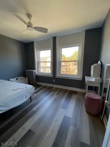 a spacious bedroom with a bed and a chair