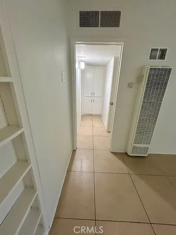 a view of a hallway to rooms