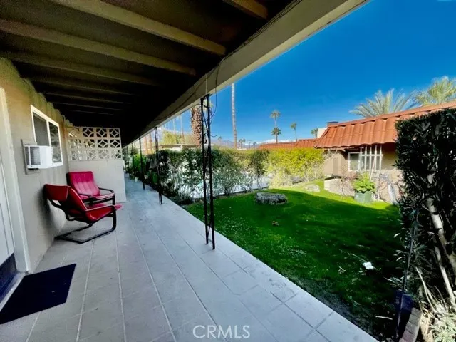 a view of a backyard with table and chairs and potted plants