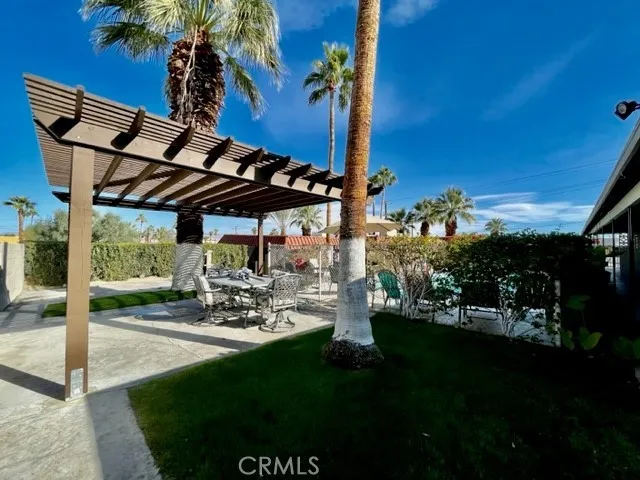 a view of a patio with table and chairs potted plants with wooden floor