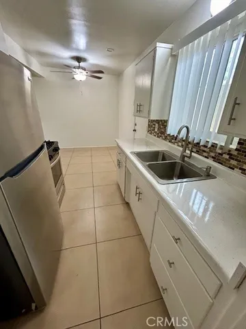 a bathroom with a double vanity sink a toilet and a mirror