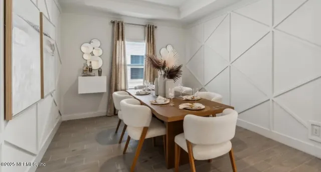 a living room with furniture kitchen view and a chandelier