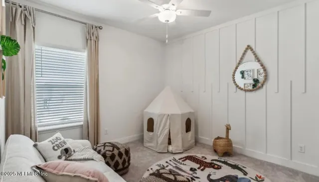 a bedroom with furniture and a large window